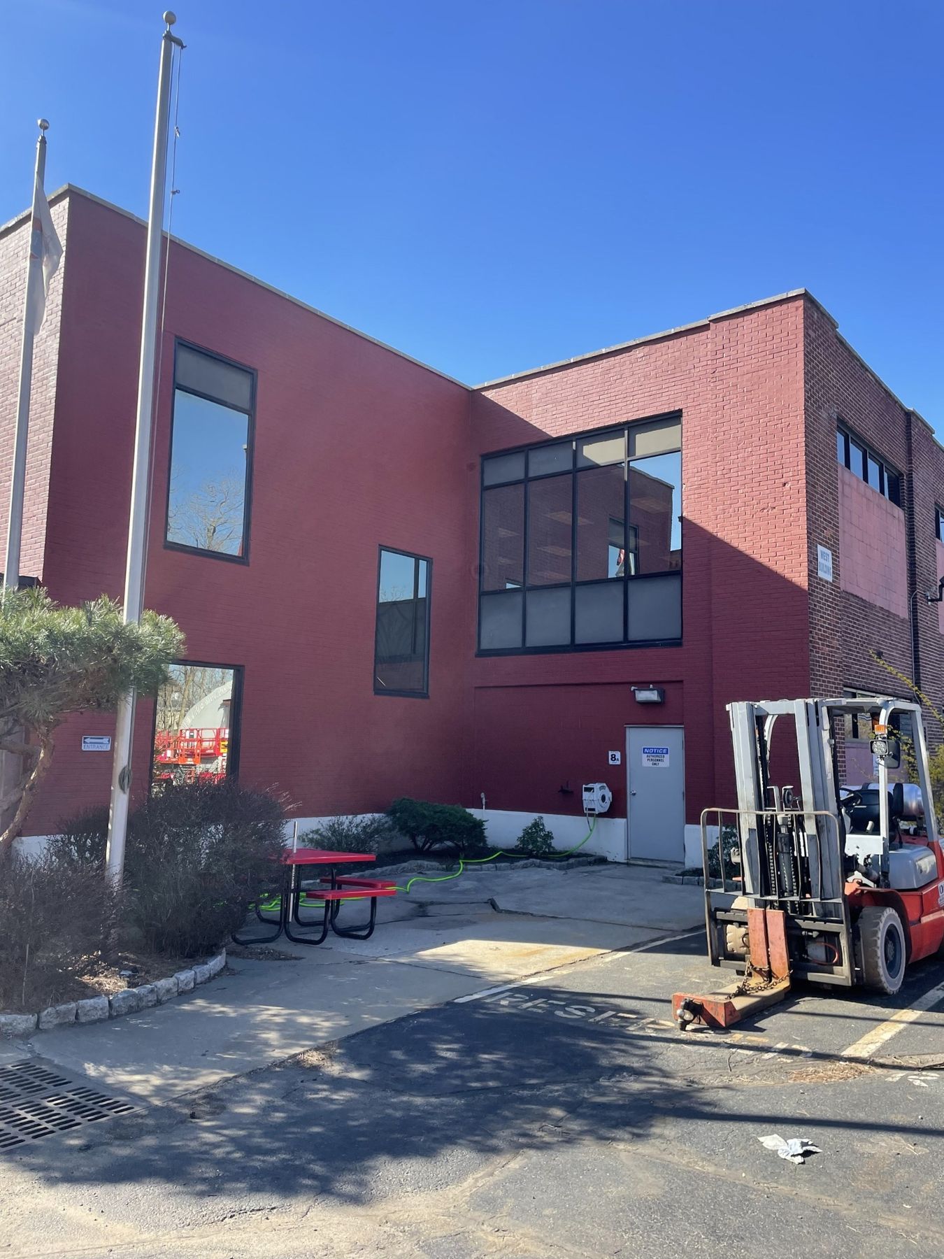 Deep red brick industrial building facade with large windows after masonry restoration