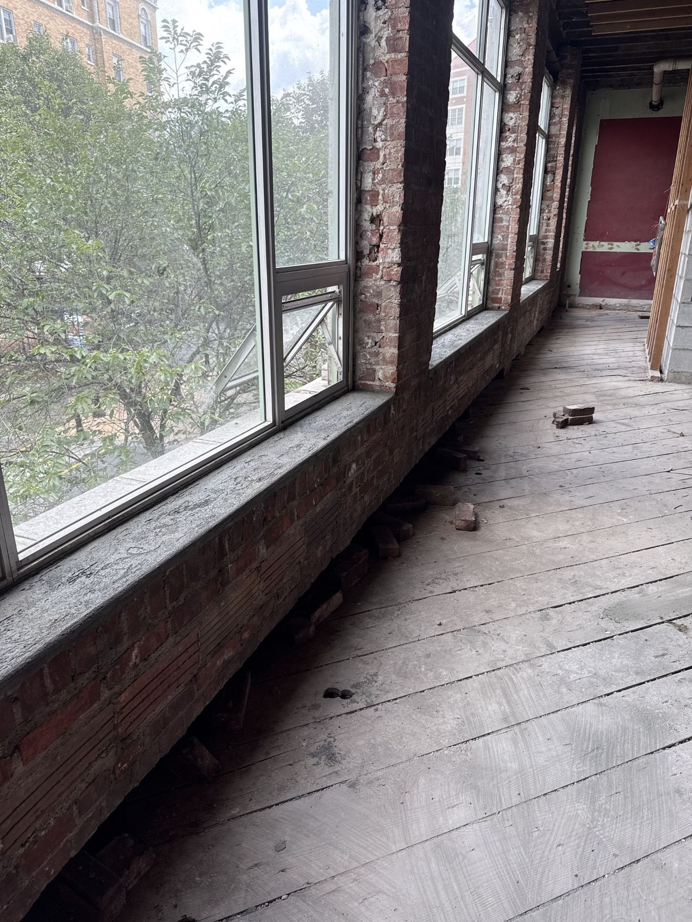 Close view of interior brick wall and rebuilt window sills during a masonry restoration