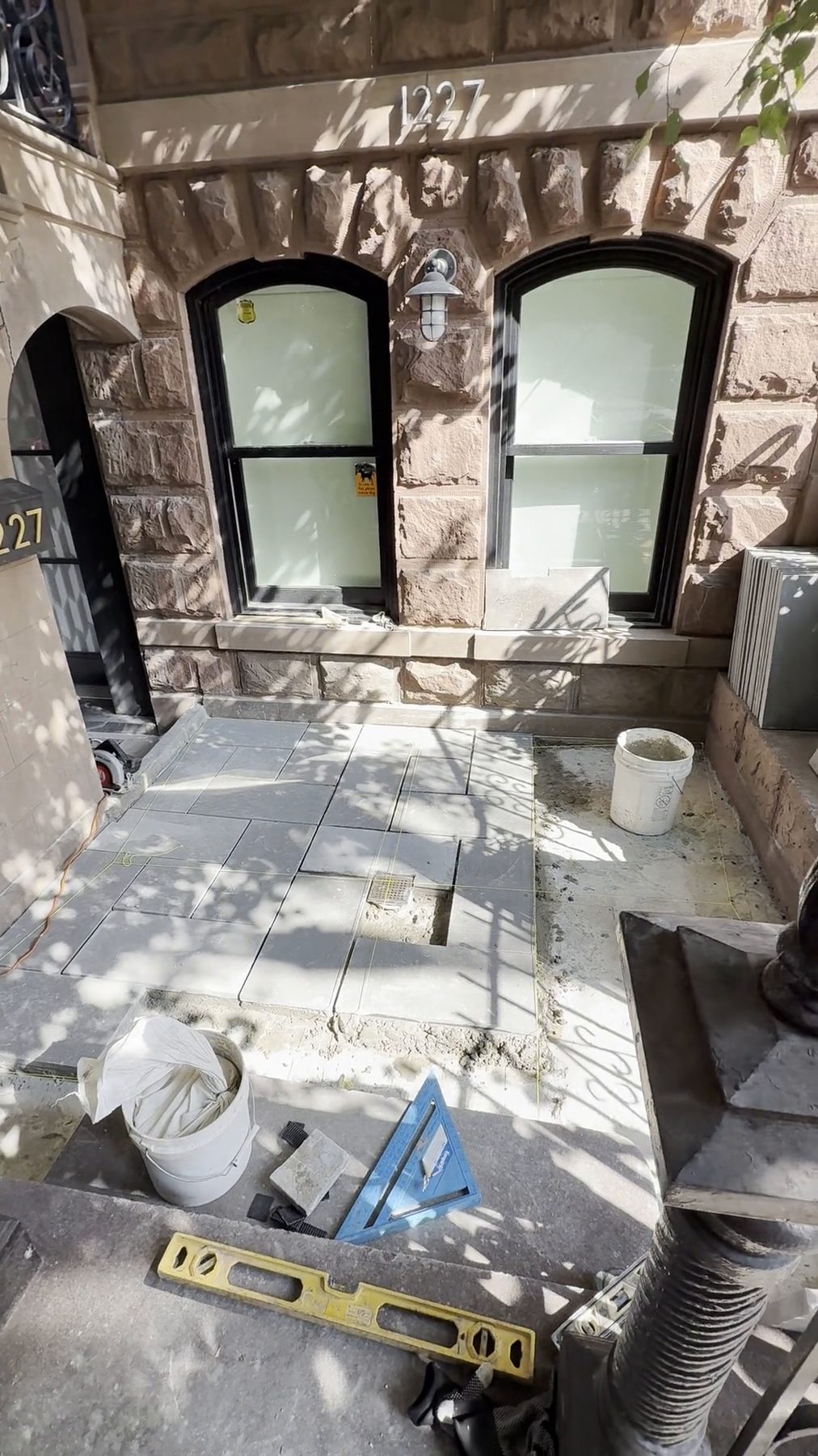 Bluestone paving and stone entry steps at the front of a restored brownstone